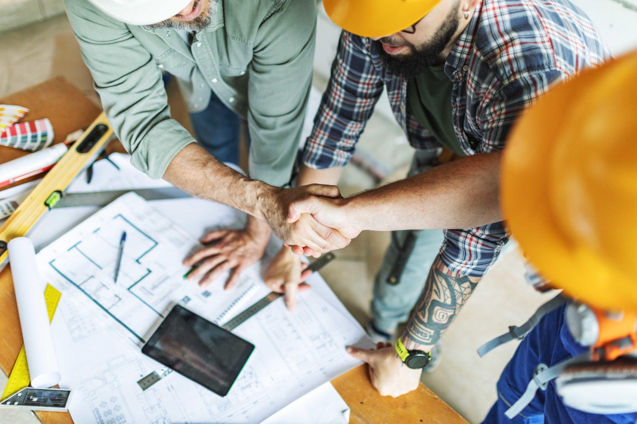Contractors shaking hands over job plans